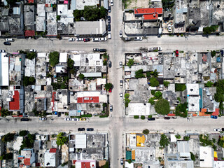 Aerial top-down view high altitude of slum a heavily populated urban informal settlement characterized by substandard housing and squalor poor living conditions streets and rusty metal home roof tops