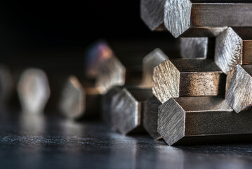 Close-up of cut metal rods stacked together, showing texture and reflections, industrial macro detail