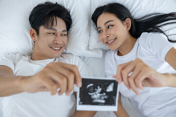 Couple Sharing Ultrasound Picture at Home