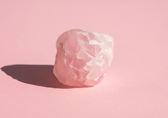 Beautiful Rough Pink Rose Quartz Crystal Stone on Pastel Background