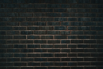 Dark brick wall surface used as architectural design and construction background. Decorative black brickwall with modern texture, urban background pattern.