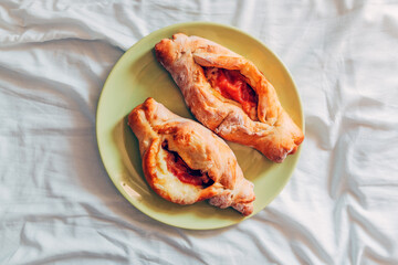 Peinirli is a Greek boat shaped pizza, served on a plate