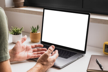 Man using laptop computer for video conference call at home, mockup screen for app interface or online communication concept, digital connection and virtual collaboration in modern workspace.