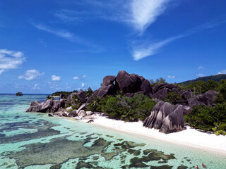 Anse Cocs beach, La Digue Seychelles, tropical beach during a luxury vacation in Seychelles. Tropical beach Anse Cocs beach, La Digue, Praslin, Mahe Seychelles with turqouse colored ocean