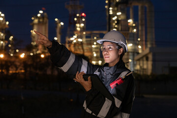 Engineers Conducting Night Inspection at Refinery