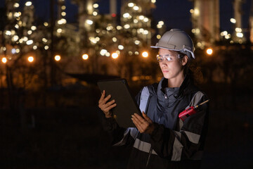 Engineers Conducting Night Inspection at Refinery