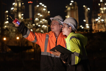 Engineers Conducting Night Inspection at Refinery