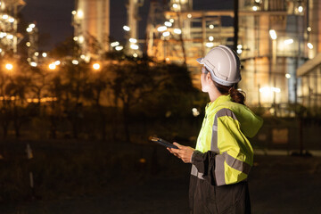 Engineers Conducting Night Inspection at Refinery