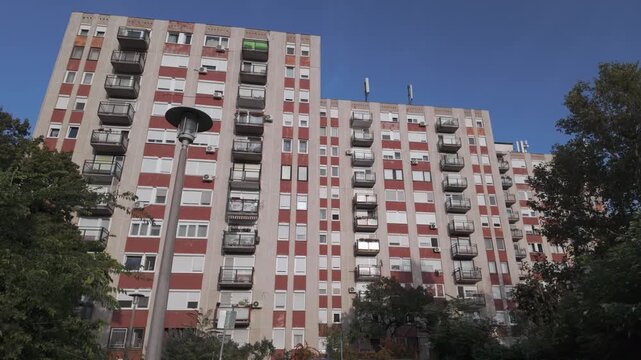 Typical post-communist panel apartment buildings on a sunny summer day on Csepel Island in Budapest, Hungary. Old, not renovated block houses with many windows, air conditioning systems and balconies
