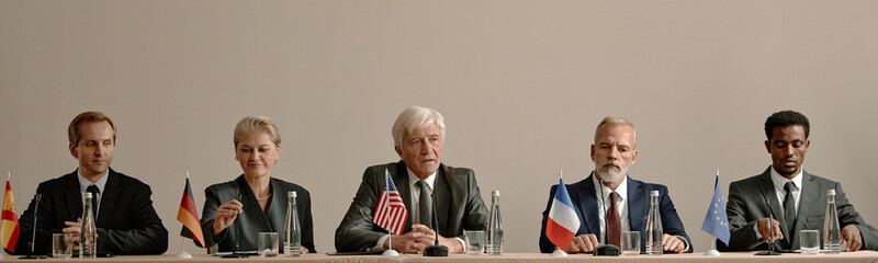 Header of group of middle aged and senior multiethnic business professionals sitting at conference...