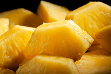 sliced pineapple on black background