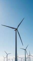 Wind Turbines in Clear Blue Sky with Moving Blades for Renewable Energy