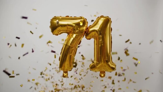 Gold balloon number 71 for birthday or anniversary party. White background with falling confetti