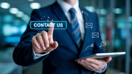 Professional businessman's hand touches glowing 'Contact Us' button on futuristic interface, symbolizing seamless communication and digital engagement.