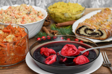 A festive table filled with traditional holiday dishes, a festive Christmas Eve dinner