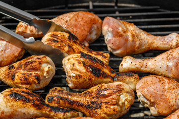 Juicy pieces of chicken charred on a very hot charcoal grill