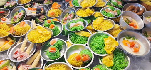 A variety of  dim sum dishes are arranged in stainless steel cups for customers to choose from. Small dishes, mostly steamed before eating. Brunch is often served with sweet - sour sauce. fusion food
