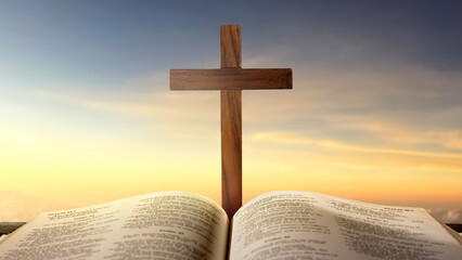 Blue book of the Holy bible and Christian cross. Standing on the table with a dramatic sky...