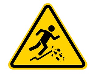 A caution sign featuring a figure tripping over an obstacle, representing a hazard