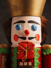 Nutcracker doll mit a gift box, close up shot