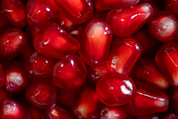 vibrant close-up of fresh pomegranate arils showcasing their rich red color and glossy texture. Perfect for illustrating concepts of health, nutrition, organic food, and freshness