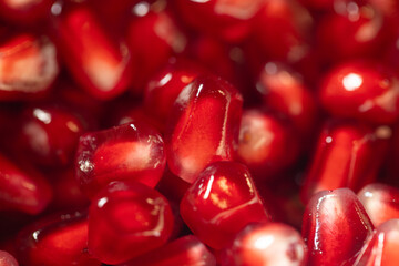 vibrant close-up of fresh pomegranate arils showcasing their rich red color and glossy texture. Perfect for illustrating concepts of health, nutrition, organic food, and freshness