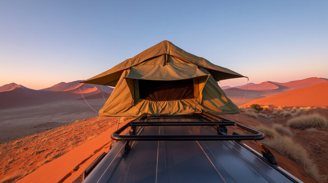 Rooftop tent on vehicle in desert dunes at sunset. Overlanding adventure camping with dramatic orange sand and mountain backdrop. Remote wilderness travel and outdoor expedition lifestyle scene. - Powered by Adobe