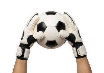 Goalkeeper's gloved hands securing a classic black and white soccer ball, prepared for action in a sports match.
