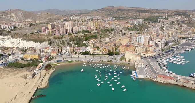 Aerial view of a bay located in Porto Empedocle, Sicily, Italy. The town overlooks the Mediterranean Sea, whose waters are a turquoise color.
