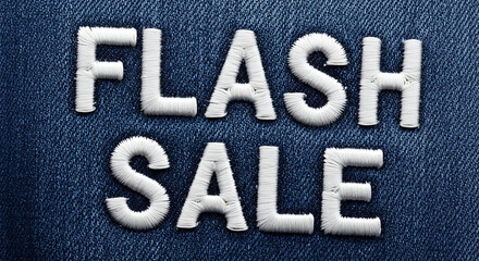 Flash sale embroidered text on blue denim texture fabric background.