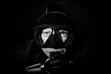 scuba diver in mask on black background
