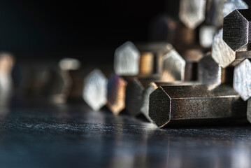 Cut metal rods stacked together, showing texture and reflections, industrial macro detail