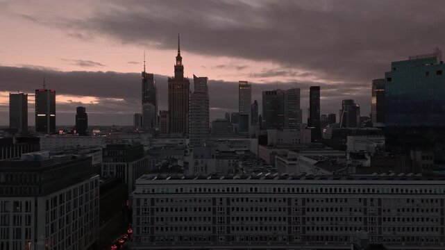 Warsaw city center skyline aerial at dusk with skyscrapers and residential buildings. Establishing shot of Warsaw city center in Poland