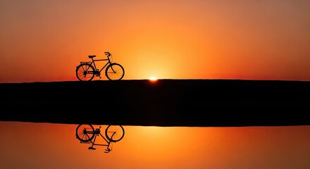 Silhouette of a Bicycle Against a Vibrant Sunset Reflecting in Water