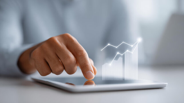 Focused business person using tablet for data analytics and finance. holographic graph shows investment growth, symbolizing success and positive future strategy