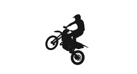 A silhouette of a person performing a wheelie on a motocross dirt bike