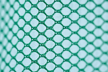 Fototapeta premium Green mesh pattern with hexagonal design on surface