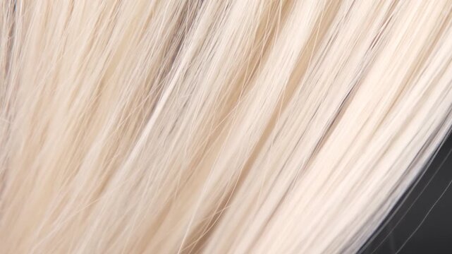Demonstration of split ends and unkempt hair on blonde hair