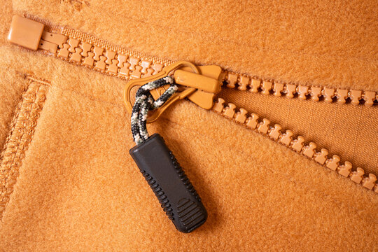 Peach Fabric with Plastic Zipper Pull — Macro Close-Up, Flat Lay - Powered by Adobe