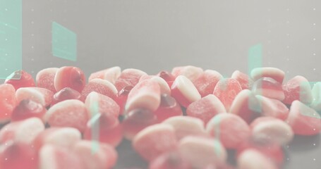 Displaying pile of sugar-coated gummy candies showing sugar crystals on table in studio, mint flare
