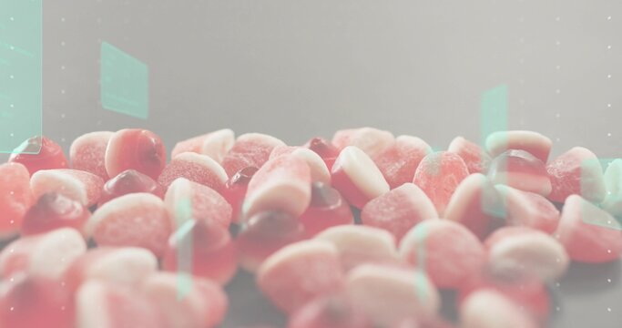 Fototapeta Displaying pile of sugar-coated gummy candies showing sugar crystals on table in studio, mint flare
