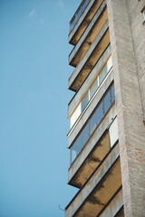 Architectural perspective of multi-story residential building with repetitive windows, symbol of urban geometry.
