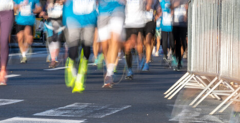 marathon runners in ljubljana close up of feet and running shoes on city street during race