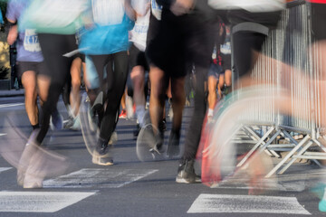 runners feet in motion during marathon race on city streets of ljubljana with blurred effect