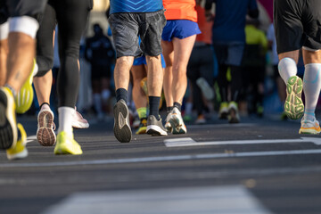 Marathon runners with close up views of legs and athletic shoes running outdoors in Ljubljana