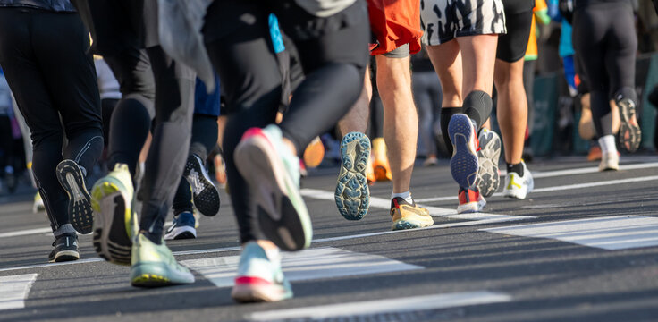 Close up of diverse runners feet during marathon running event in Ljubljana urban setting