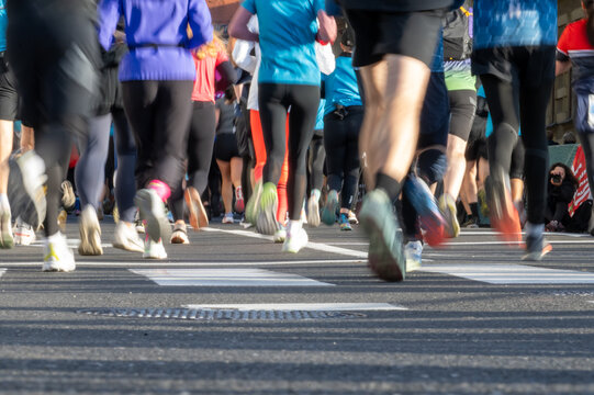 Close up of diverse runners feet in motion participating in a marathon in Ljubljana city outdoors