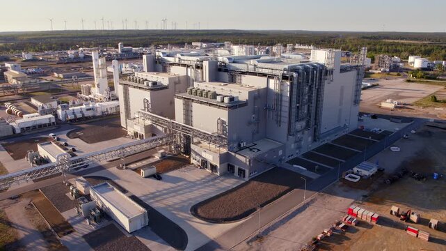 The drone flies over a large industrial complex. Warm evening light highlights pipes, structures, and production buildings from an elevated viewpoint.BASF Schwarzheide 
