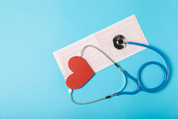 Medical stethoscope, red heart, and cardiogram on a color background. ECG, Heart wave, heart attack, cardiogram report. Cardiogram pulse trace and heart concept. Healthcare.Space for text