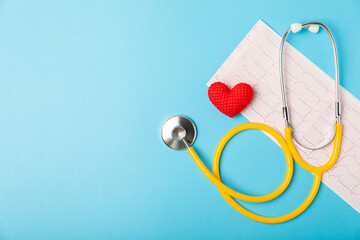 Medical stethoscope, red heart, and cardiogram on a color background. ECG, Heart wave, heart attack, cardiogram report. Cardiogram pulse trace and heart concept. Healthcare.Space for text